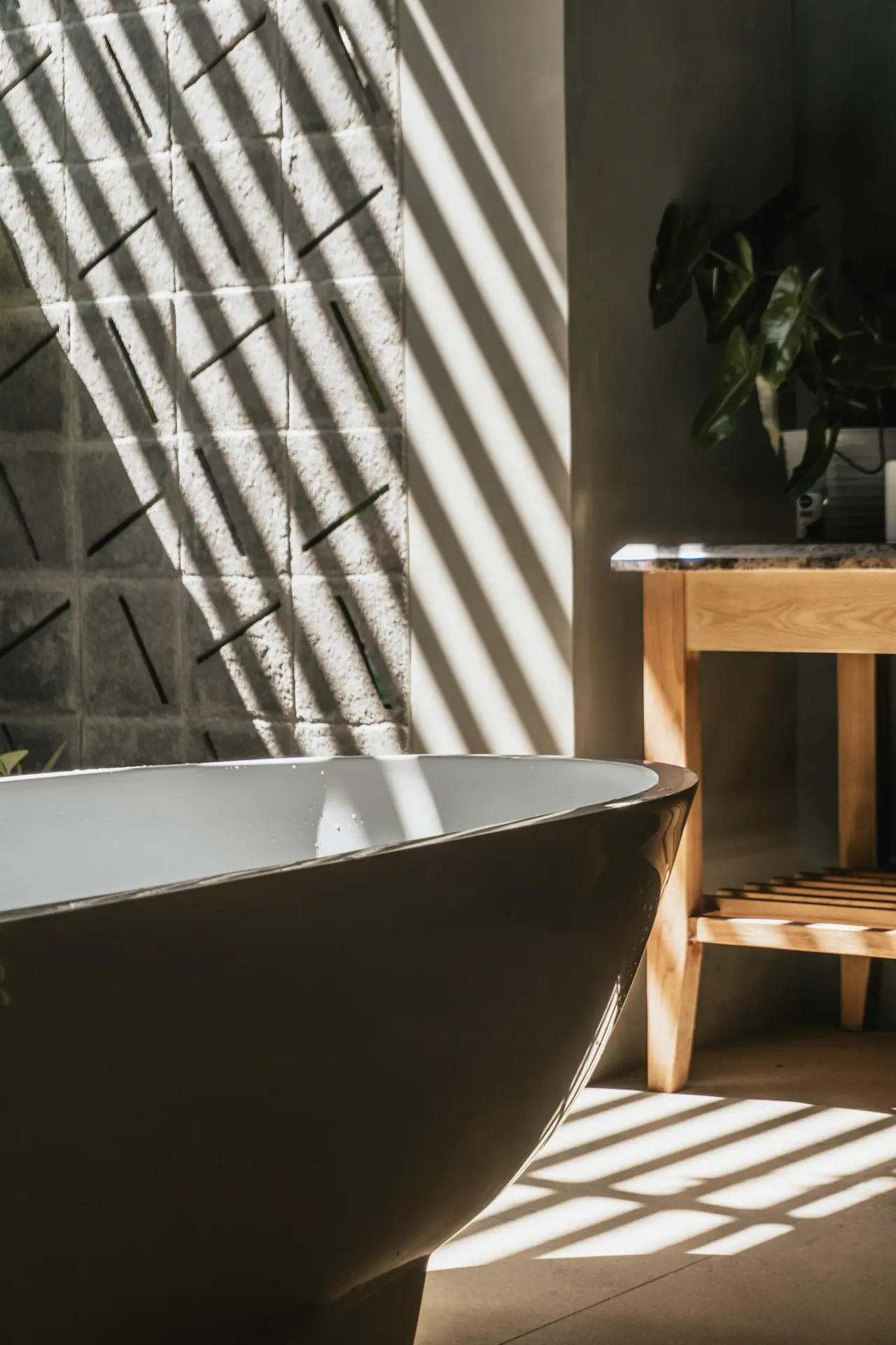 Sunlight falling across a freestanding bath