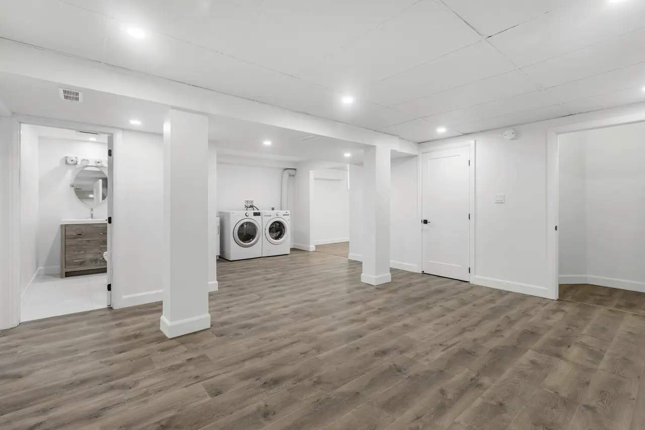 A bright, empty room with new flooring, ready for handover