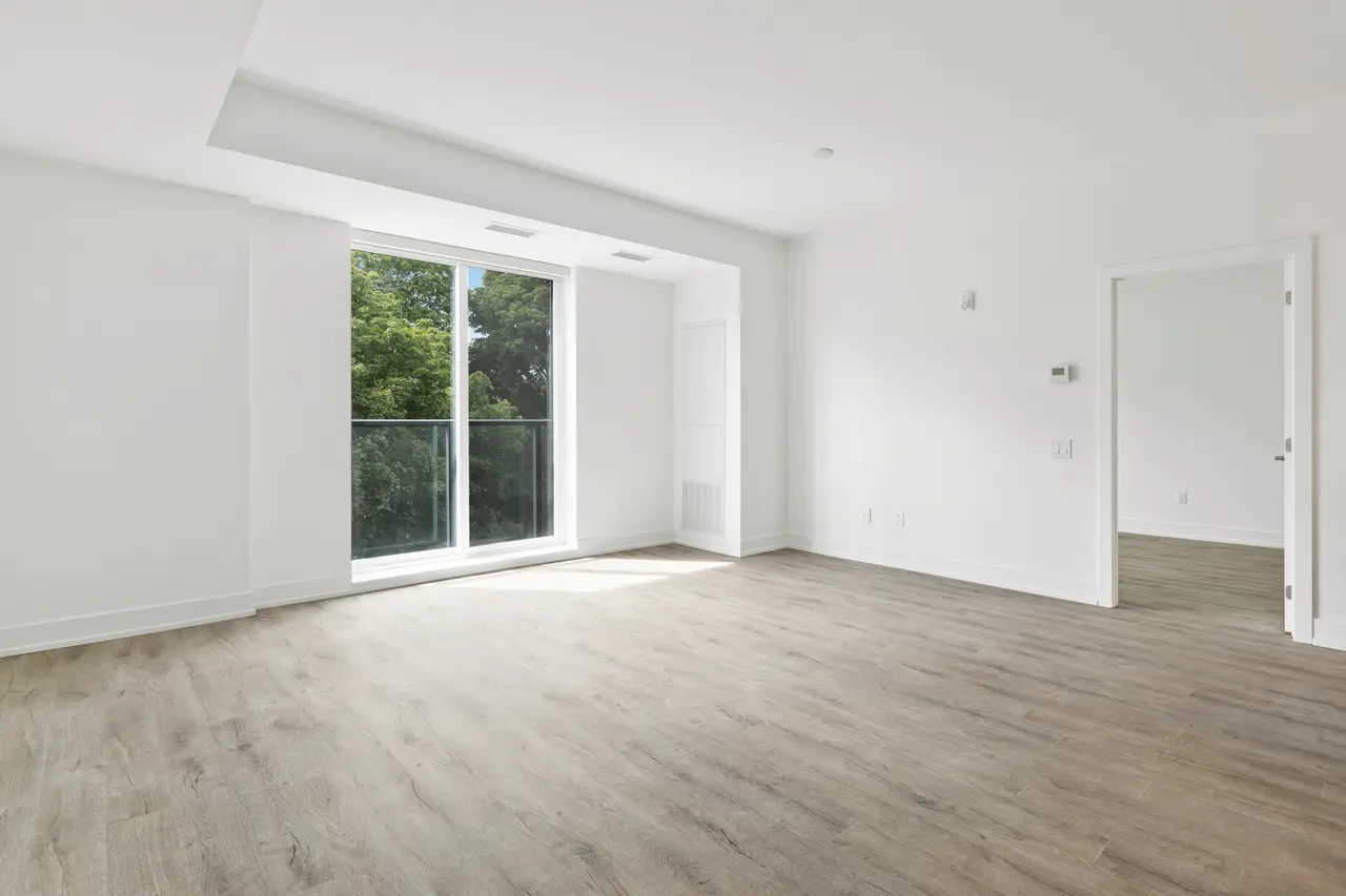 An empty, freshly cleaned room with timber-look floors