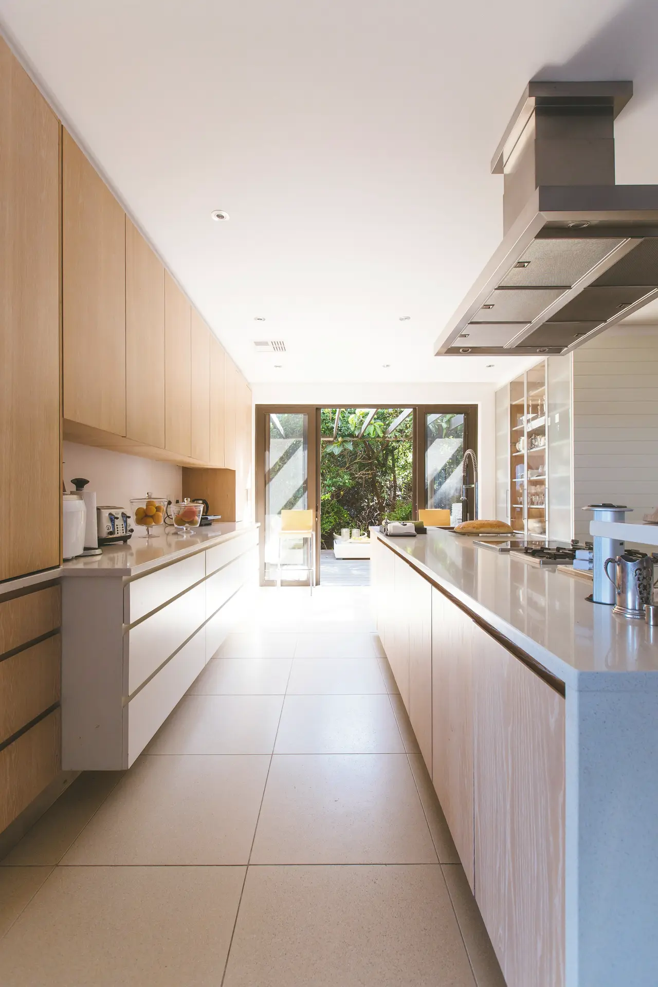A long, clean galley kitchen with timber cabinetry