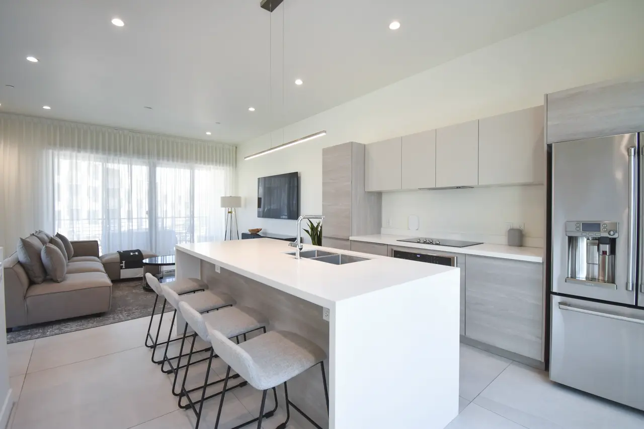 A bright white kitchen and living area