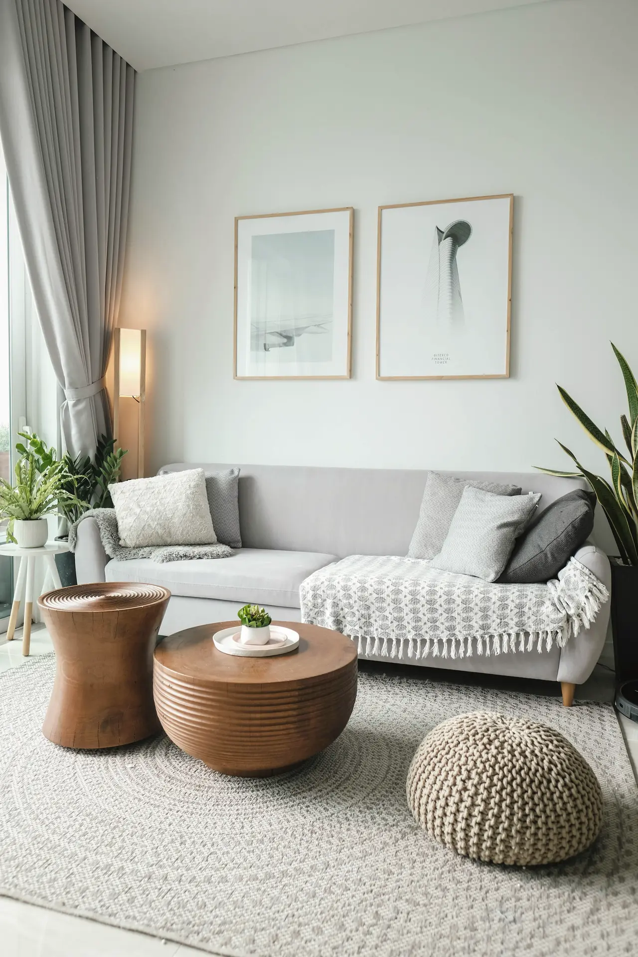 A calm living room with a round rug and timber side tables