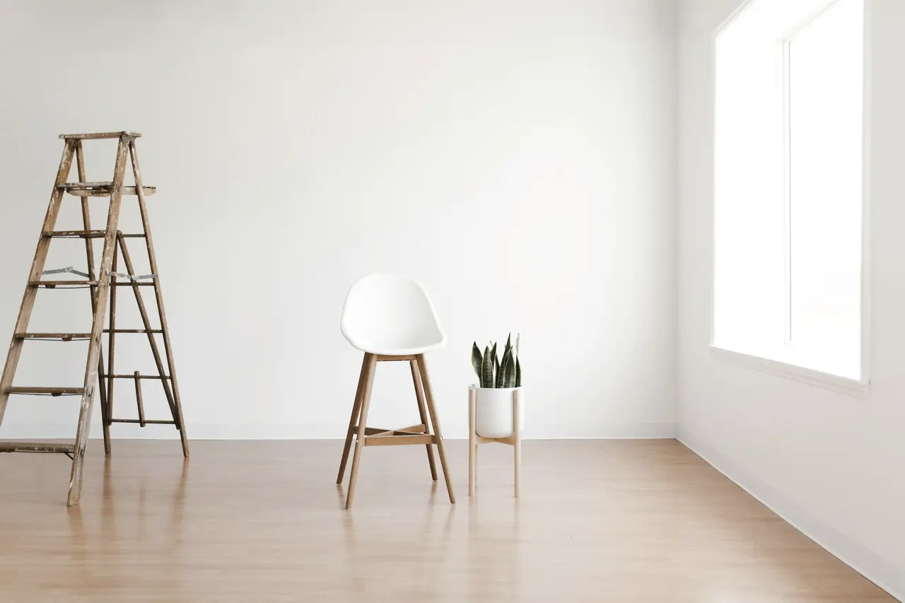 A freshly renovated room with a ladder and stool left behind