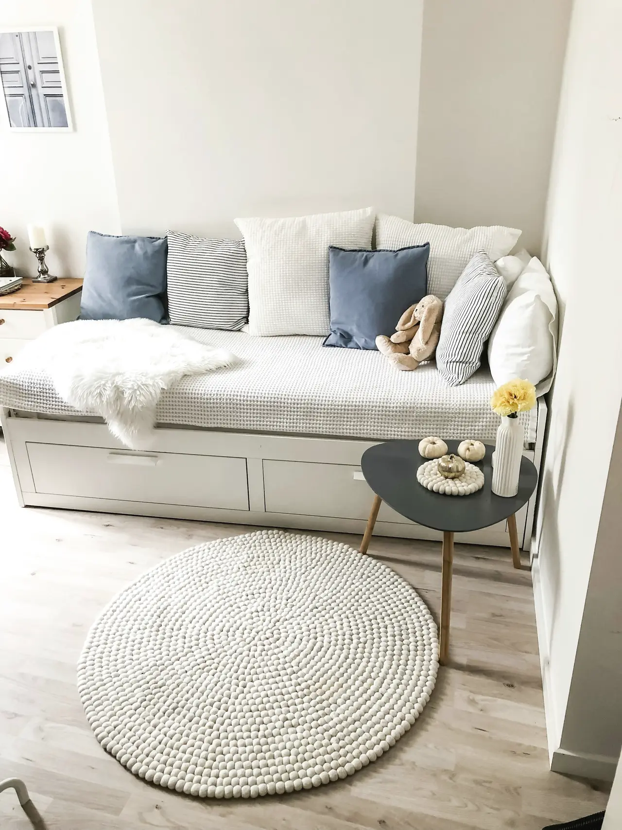A round woven rug in a light living room