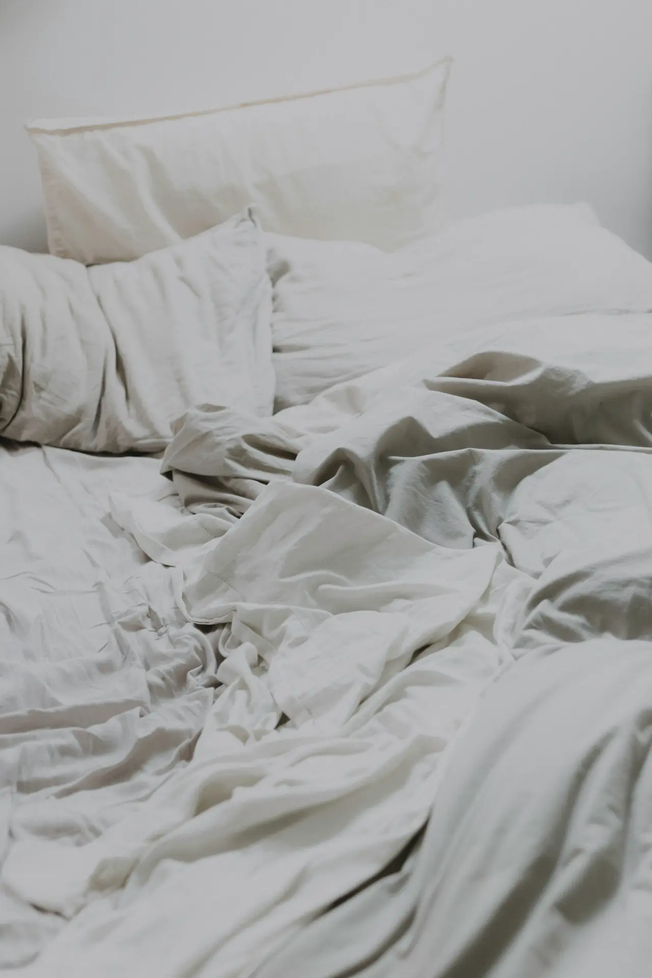 Crumpled sheets on a bed after a guest has checked out