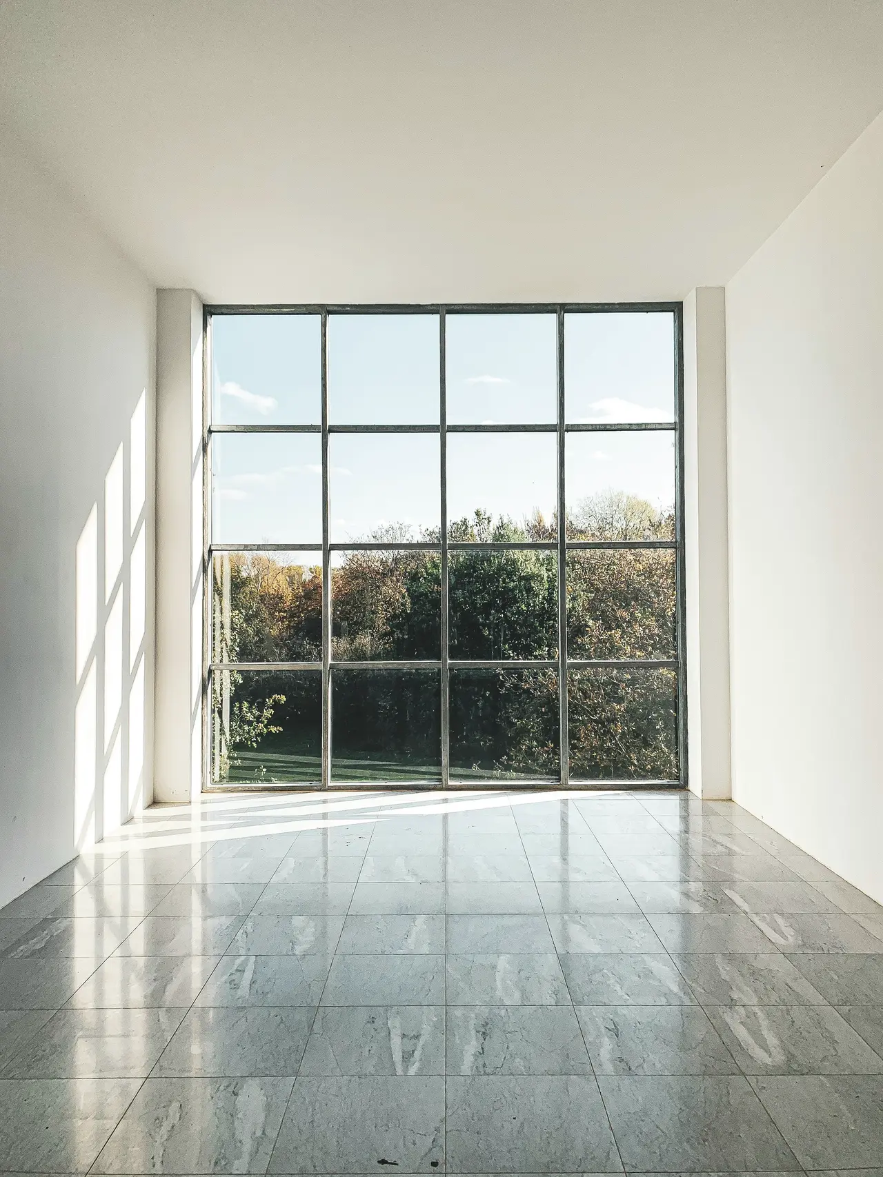 A tall window letting light onto a polished floor